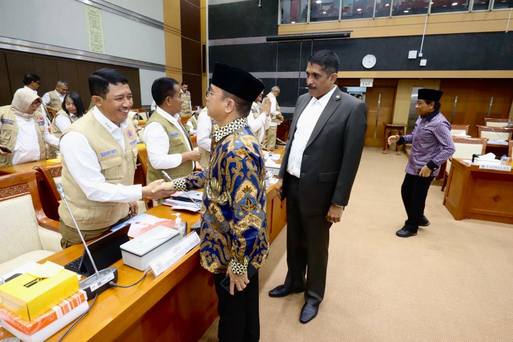 Kepala BNPB Letjen TNI Suharyanto S.Sos., M.M., (kiri) bersalaman dengan Anggota Komisi VIII DPR RI Yandri Susanto (memakai batik) usai melakukan rapat kerja antara BNPB dengan Komisi VIII DPR RI di Kompleks Senayan, Jakarta Pusat, Selasa (30/5). 